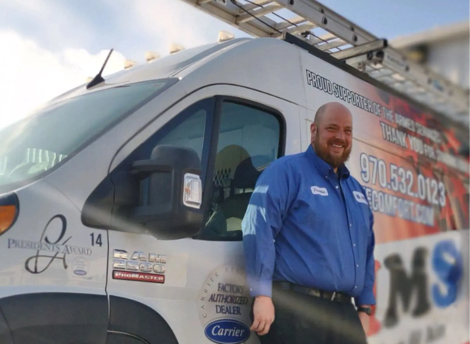 HVAC tech standing next to van