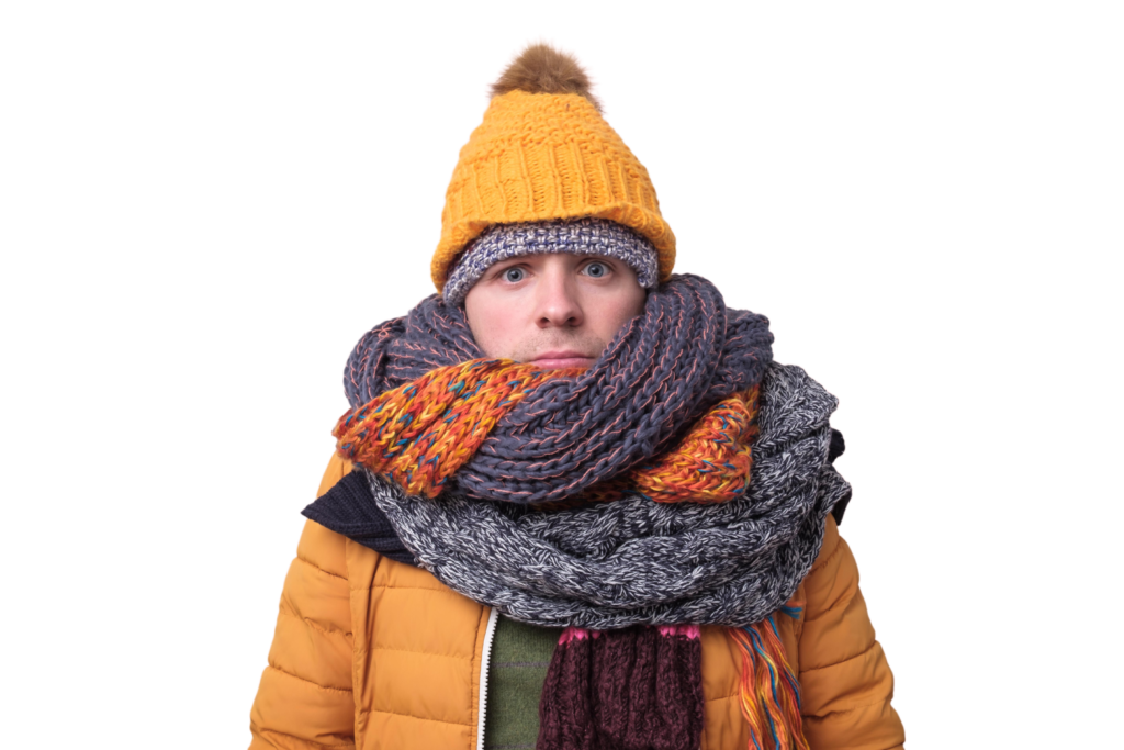 Young child wearing a yellow knit beanie with pom-pom, orange and gray striped scarf, and orange puffy jacket against white background.