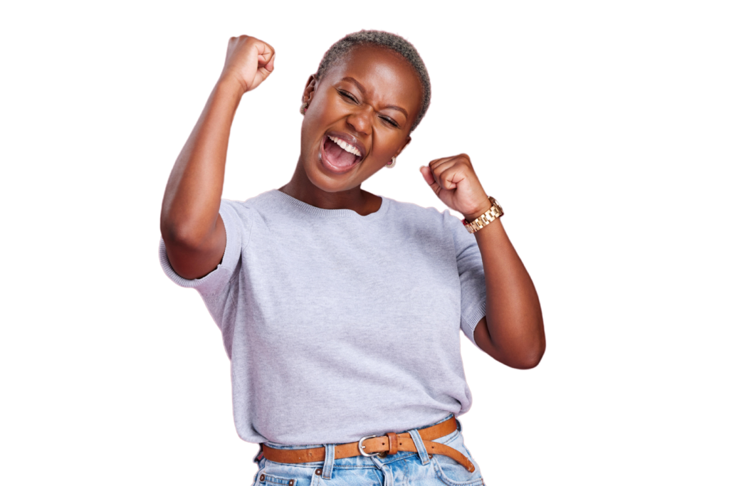 Woman in light purple t-shirt and tan belt celebrating with raised fists and big smile against white background.